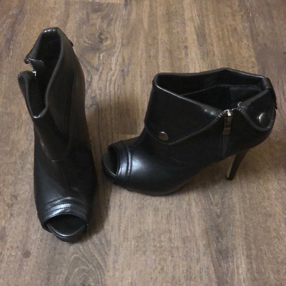 Black ankle booties. Open toe zipper details